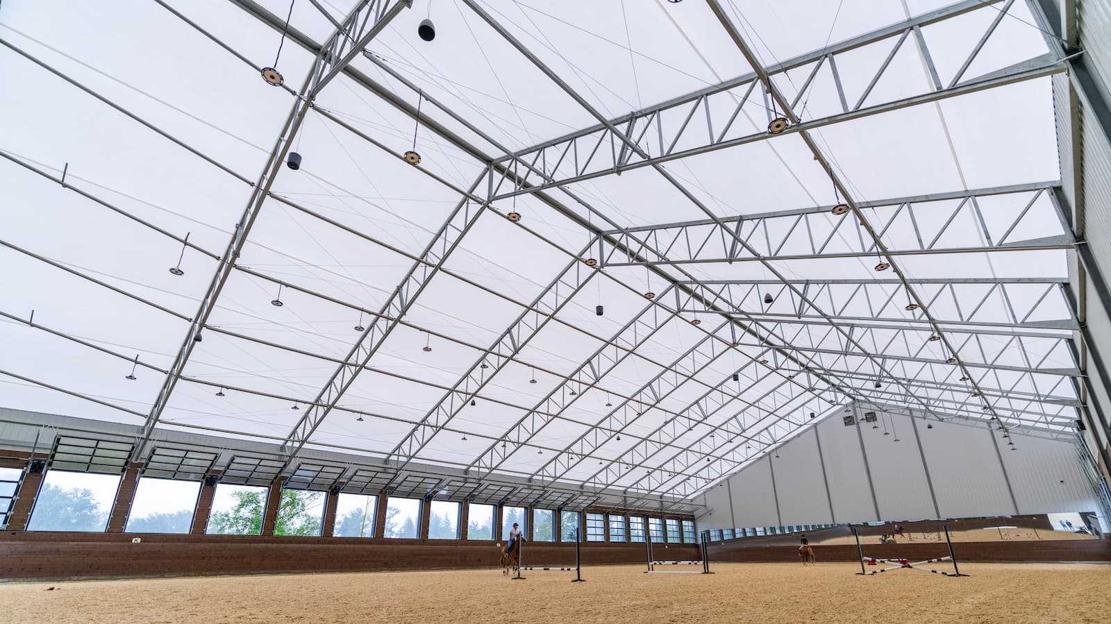 Interior of a 106' x 180' fabric roof riding arena.