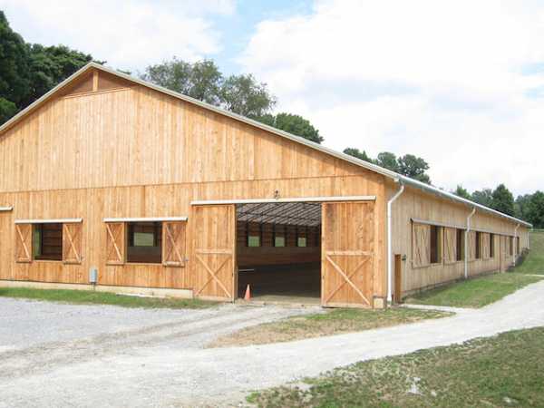 A custom made wood frame, fabric roof riding arena.