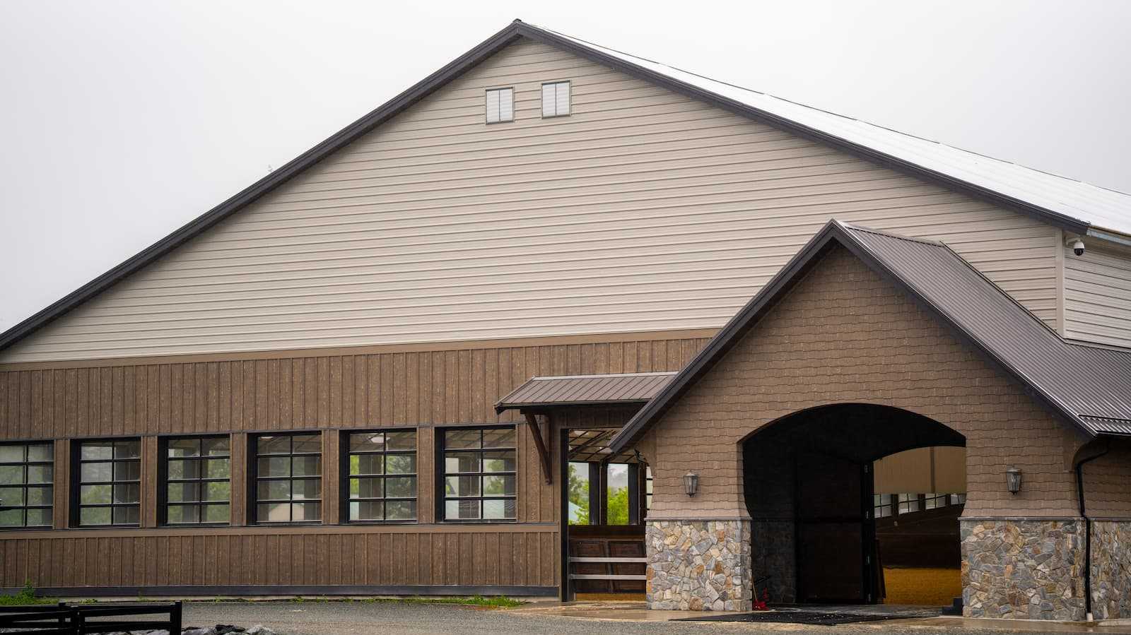 Exterior of a 106' x 180' fabric roof riding arena.