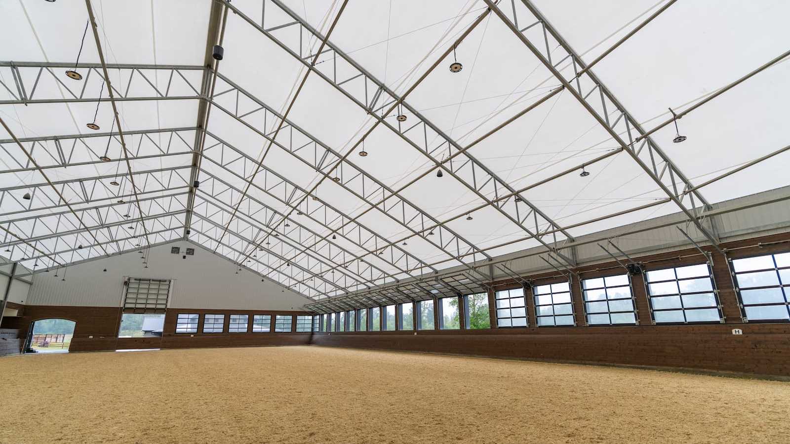 Interior of a 106' x 180' fabric roof riding arena.