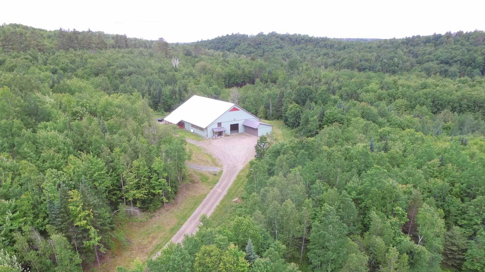 Exterior of a 85’ x 120’ fabric roof riding arena.