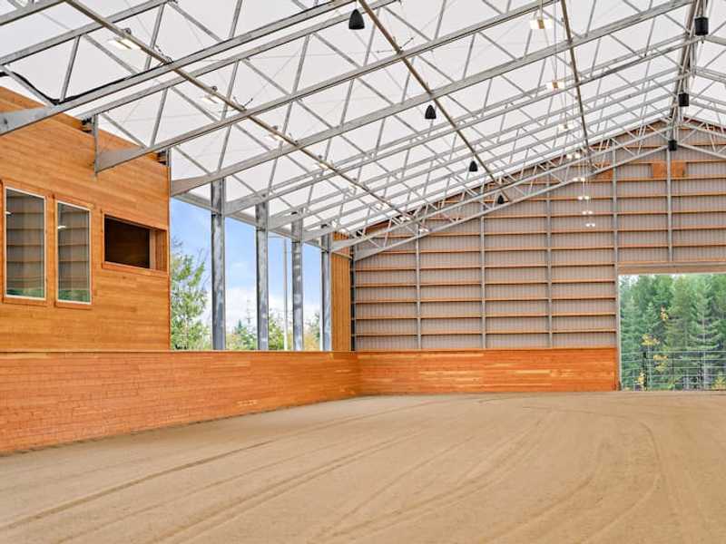 A light-filled fabric roof riding  arena.