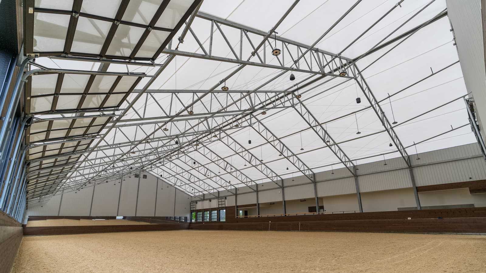 Interior of a 106' x 180' fabric roof riding arena.